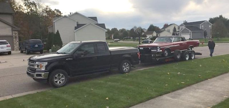 Black Truck with Car Haulers in Howell MI